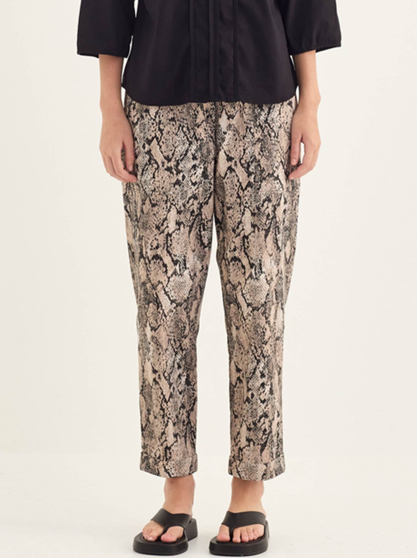 Image of a model wearing Pants. Product name - Verge Serpent Pant in Print colour by brand - Verge