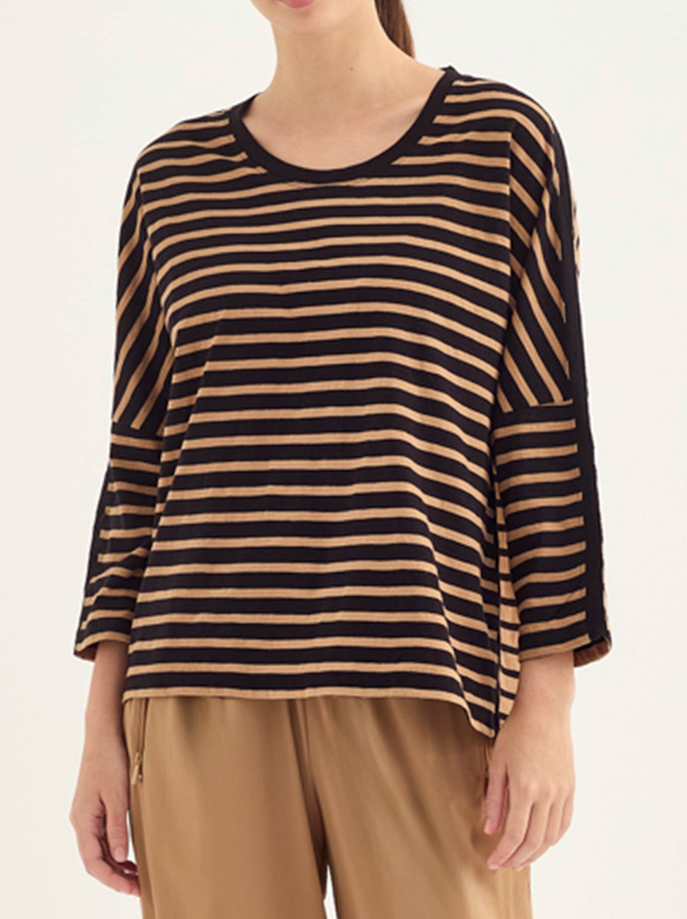 Image of a model wearing Tops. Product name - Verge Scenic Top in Black/Caramel colour by brand - Verge