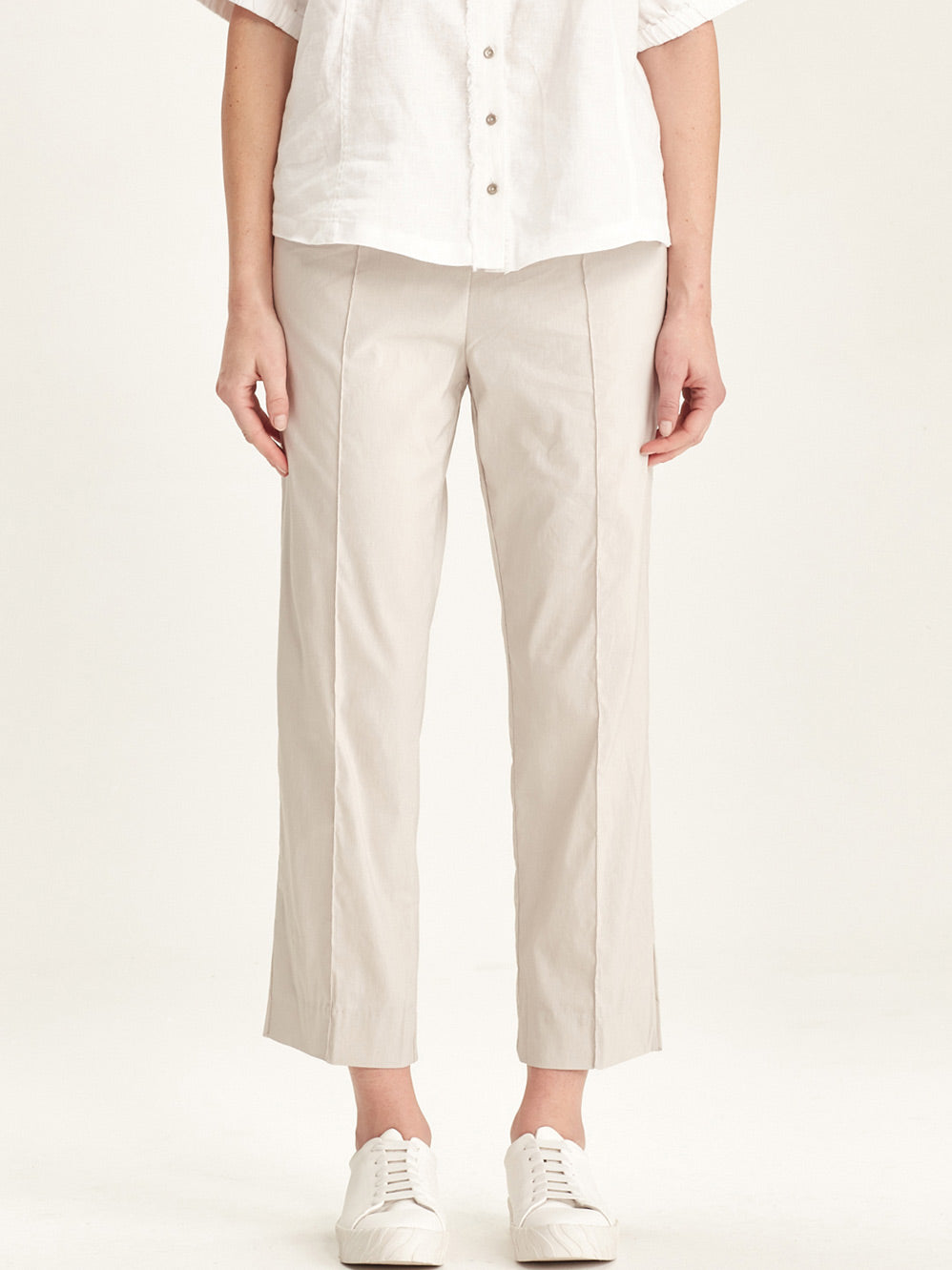 Image of a model wearing Pants. Product name - VERGE ACROBAT 7/8 PANT in Pumice colour by brand - Verge