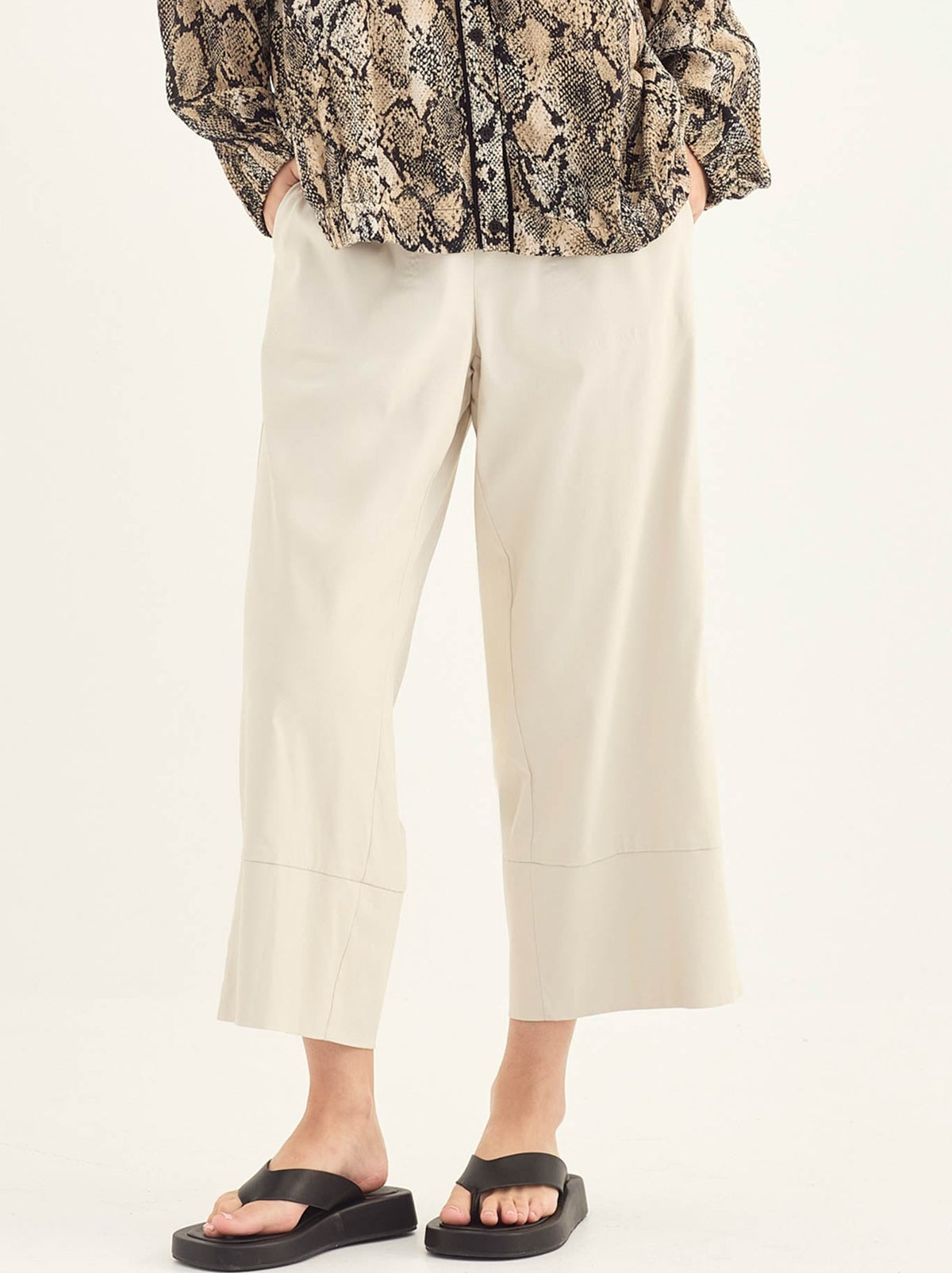 Image of a model wearing Pants. Product name - Verge Rico Pant in Putty colour by brand - Verge