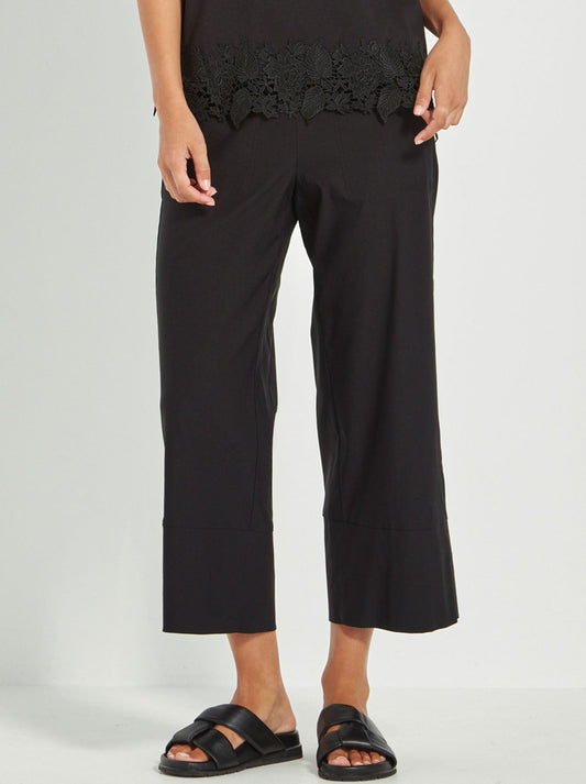 Image of a model wearing Pants. Productname: VERGE RICO PANT in Black colour by brand - Verge