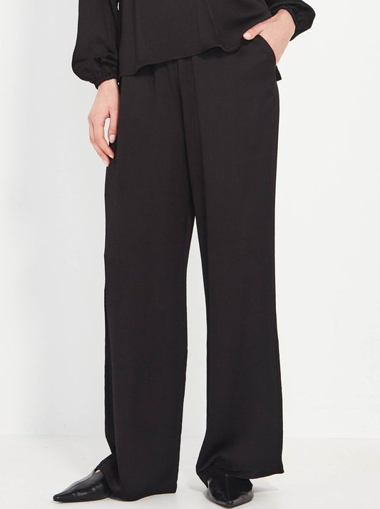 Image of a model wearing Pants. Productname: Verge Savant Pant in Black colour by brand - Verge