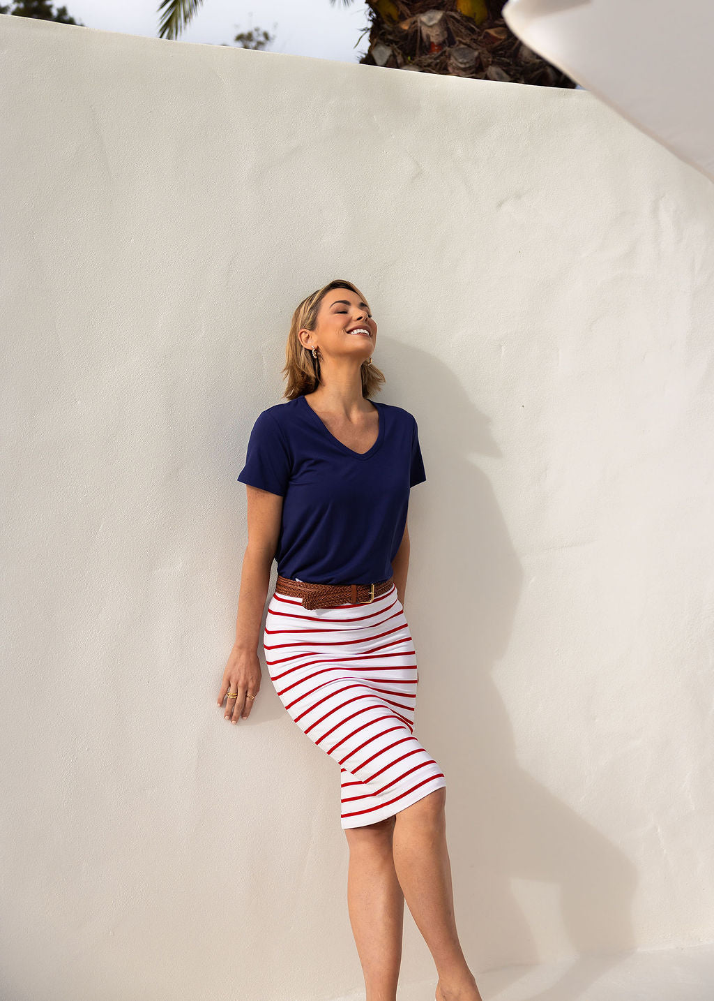 Image of a model wearing Skirts. Product name - Midi Bamboo Whitney Tube Skirt Lipstick & White Stripe in Lipstick & White Stripe colour by brand - Lou Lou