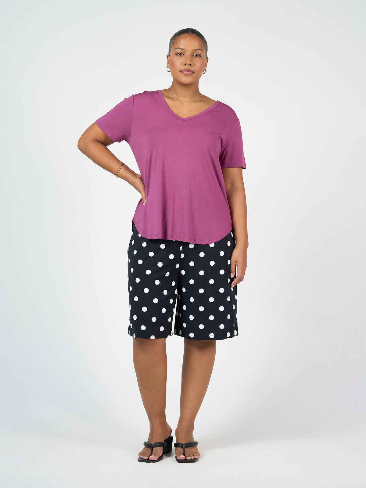 Image of a model wearing Tops. Product name - Veronica Bamboo V-Neck T-Shirt Plum in Plum colour by brand - Lou Lou