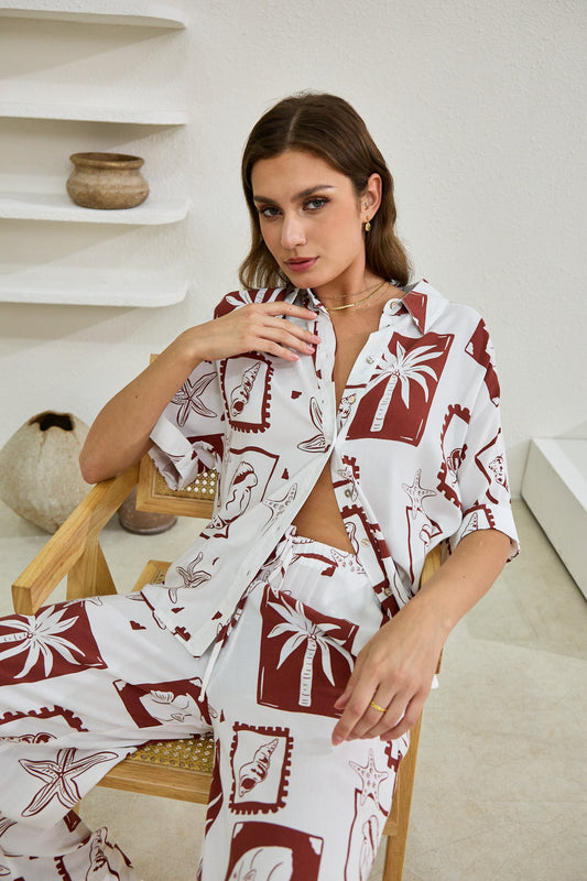 Image of a model wearing Tops. Productname: Heychic Mira Sea Shells Tropical Shirt in Brown colour by brand - Heychic