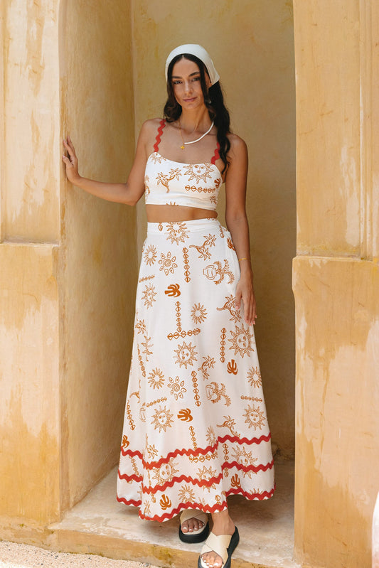 Image of a model wearing Pants. Productname: Heychic Solara Orange Tropical Ric Rac Maxi Skirt in White colour by brand - Heychic