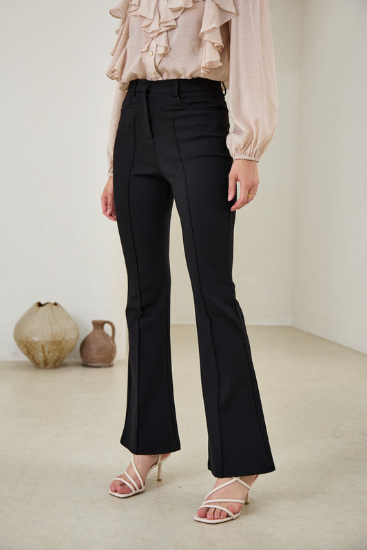 Image of a model wearing Pants. Productname: Heychic Demi Flared Pants in Black colour by brand - Heychic