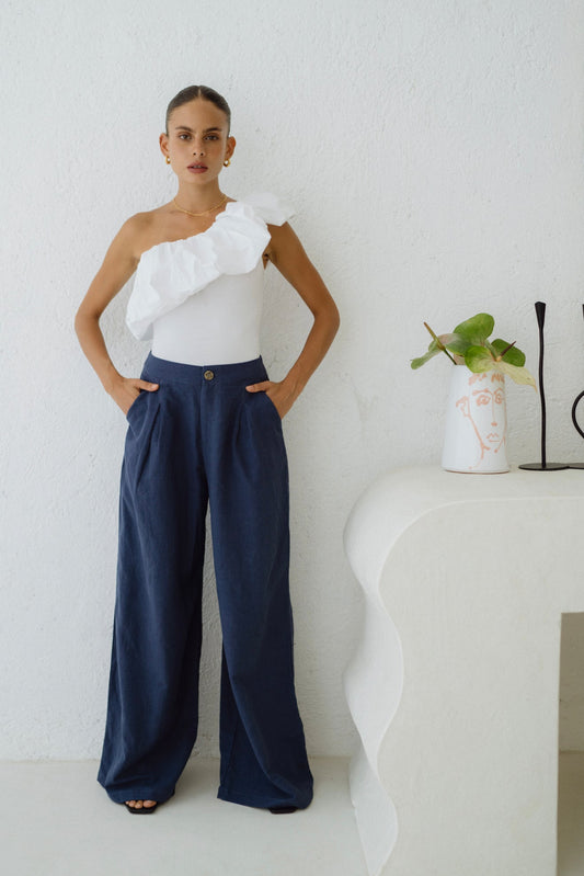 Image of a model wearing Pants. Productname: Heychic Maggie Blue Wide Leg Pants in Navy colour by brand - Heychic