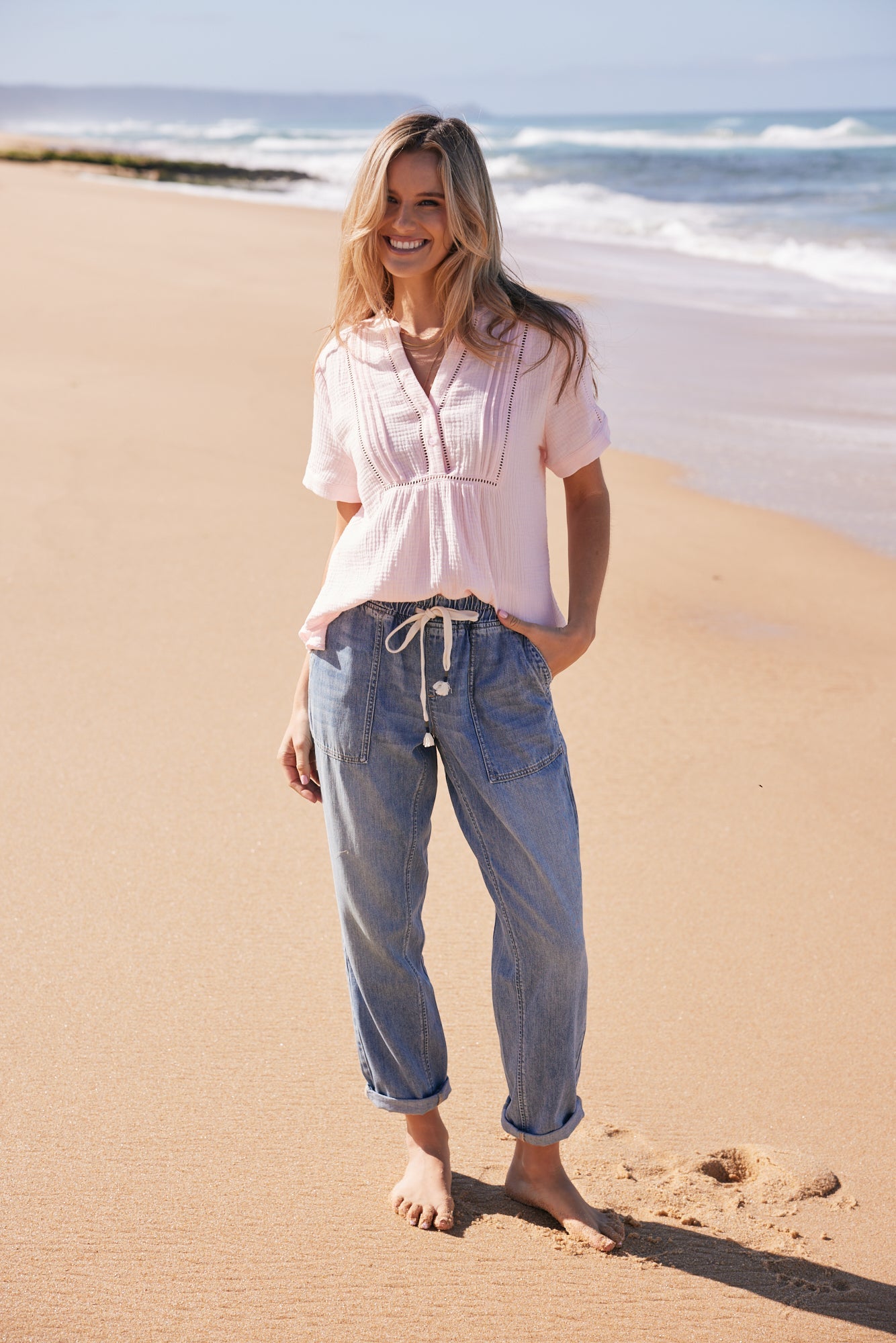 Image of a model wearing Pants. Productname: Beach Comber Pant - in Mid Wash colour by brand - White & Co.