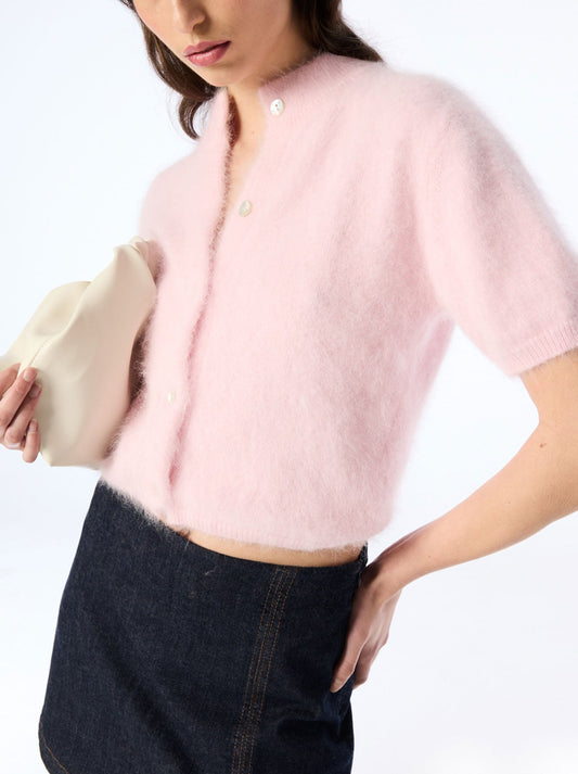 Image of a model wearing Outerwear. Product name - WORLD OF NOMADS CLAUDIA SHORT SLEEVE CASHMERE CARDIGAN in Rosewater colour by brand - World Of Nomads