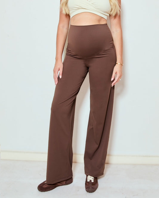 Image of a model wearing Pants. Product name - Wide Leg Overbelly Leggings in colour by brand - Soon Maternity