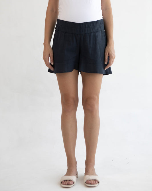 Image of a model wearing Shorts. Product name - Wide Linen Shorts in colour by brand - Soon Maternity