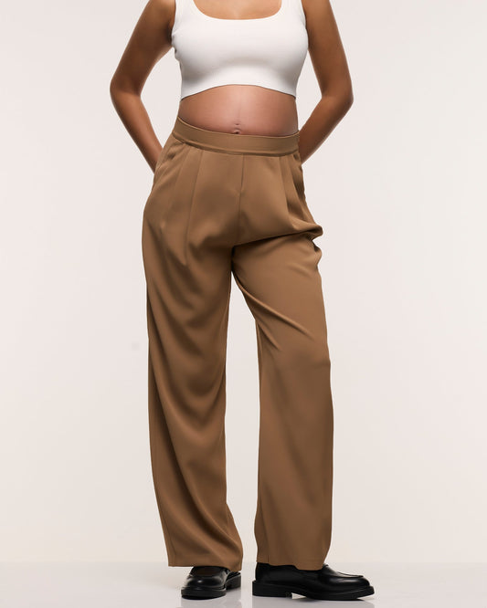 Image of a model wearing Pants. Product name - Wide Leg Pleated Pants in colour by brand - Soon Maternity