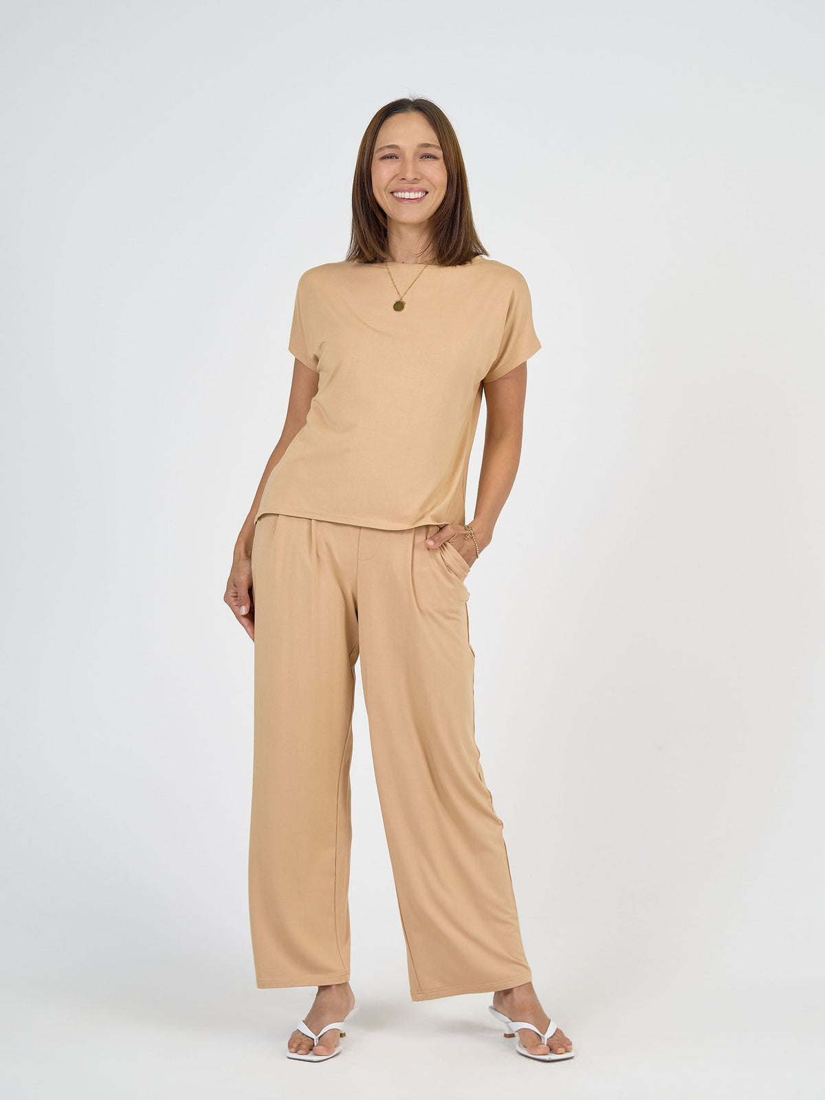 Image of a model wearing Tops. Product name - Wilde Bamboo Box Fit Tee Tan in Tan colour by brand - Lou Lou