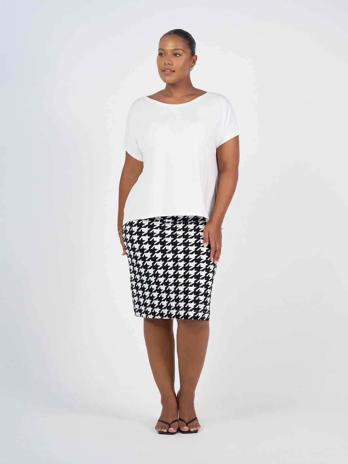 Image of a model wearing Tops. Product name - Wilde Bamboo Box Fit Tee Cream in Cream colour by brand - Lou Lou