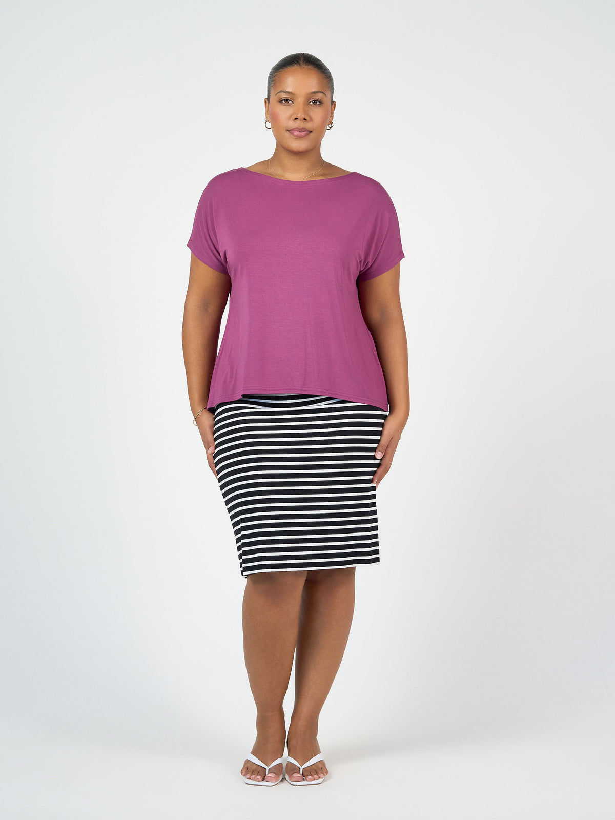 Image of a model wearing Tops. Product name - Wilde Bamboo Box Fit Tee Plum in Plum colour by brand - Lou Lou