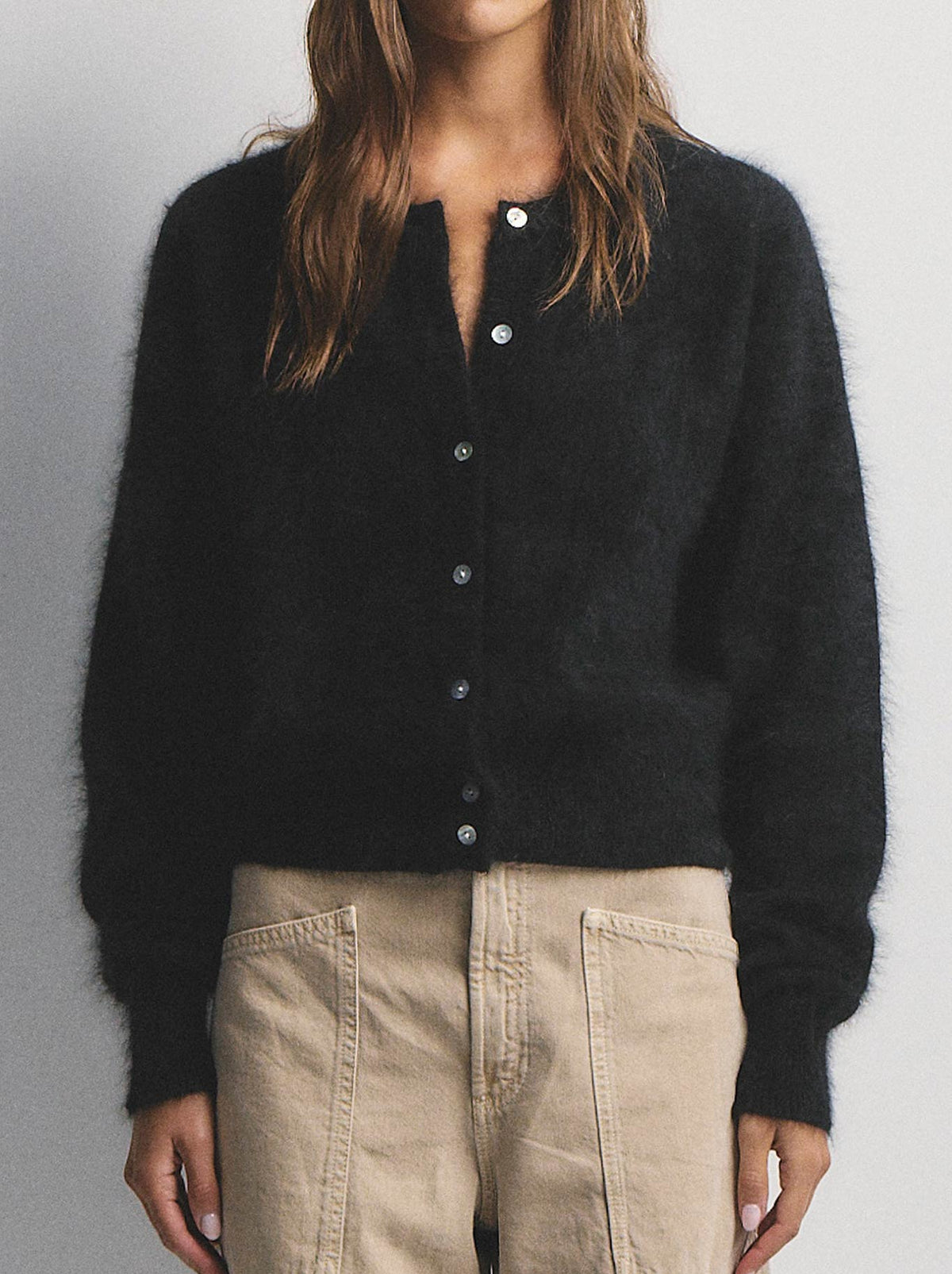 Image of a model wearing Outerwear. Product name - WORLD OF NOMADS FRANKIE CREW NECK CASHMERE CARDIGAN in Black colour by brand - World Of Nomads