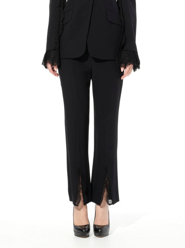 Image of a model wearing Pants. Productname: ALEXANDER MCQUEEN Leaf Lace Cig Pants in BLACK colour by brand - ALEXANDER MCQUEEN
