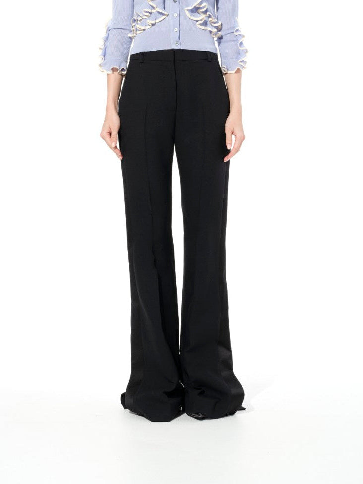 Image of a model wearing Pants. Product name - Alexander McQueen Light Wool Pant in Black colour by brand - ALEXANDER MCQUEEN