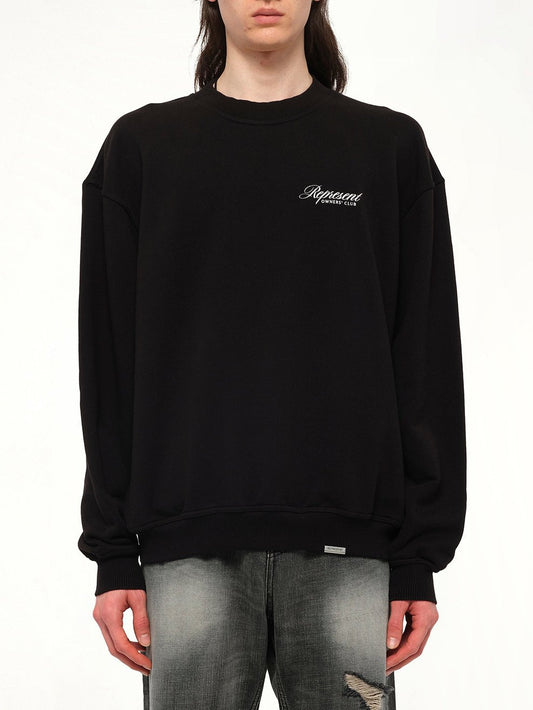 Image of a model wearing Outerwear. Productname: Represent Owners Club Script Sweater in Black colour by brand - REPRESENT