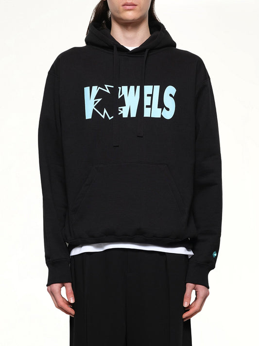 Image of a model wearing Outerwear. Productname: VOWELS Icon Spell Out Hoodie in Black colour by brand - VOWELS