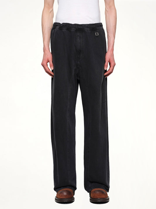 Image of a model wearing Pants. Productname: WOOYOUNGMI Denim Sweatpants in BLACK colour by brand - WOOYOUNGMI
