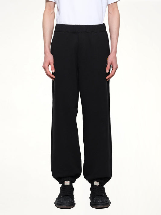Image of a model wearing Pants. Productname: VOWELS Floral Embroidered Sweatpant in Black colour by brand - VOWELS