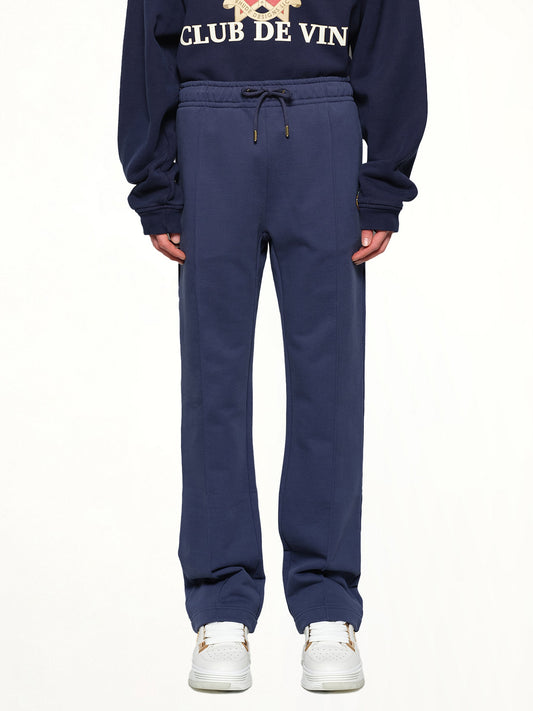 Image of a model wearing Pants. Productname: CASABLANCA Patch Open Hem Jogger in NAVY colour by brand - CASABLANCA
