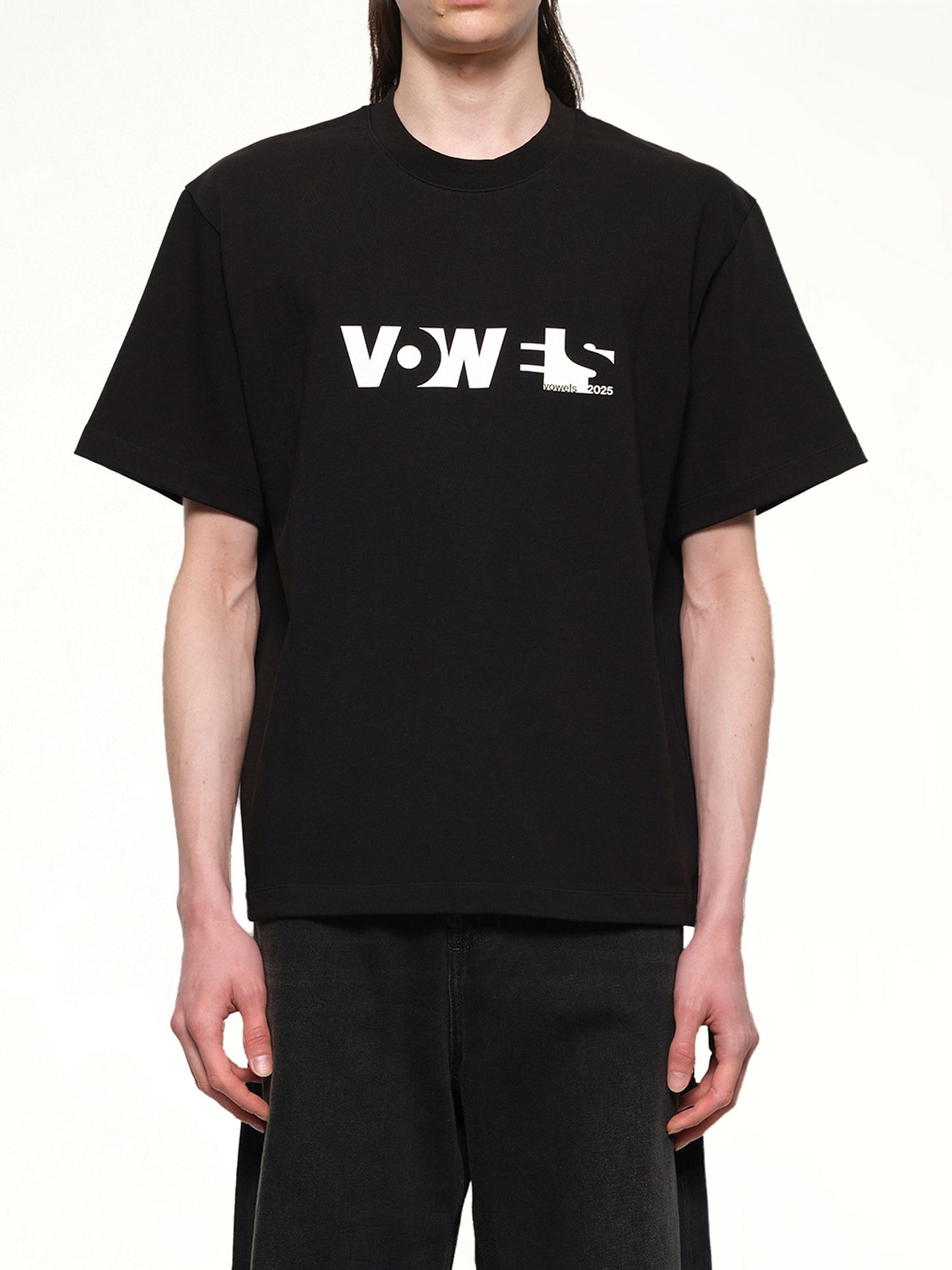 Image of a model wearing Pants. Productname: VOWELS Overall T-Shirt in Black colour by brand - VOWELS