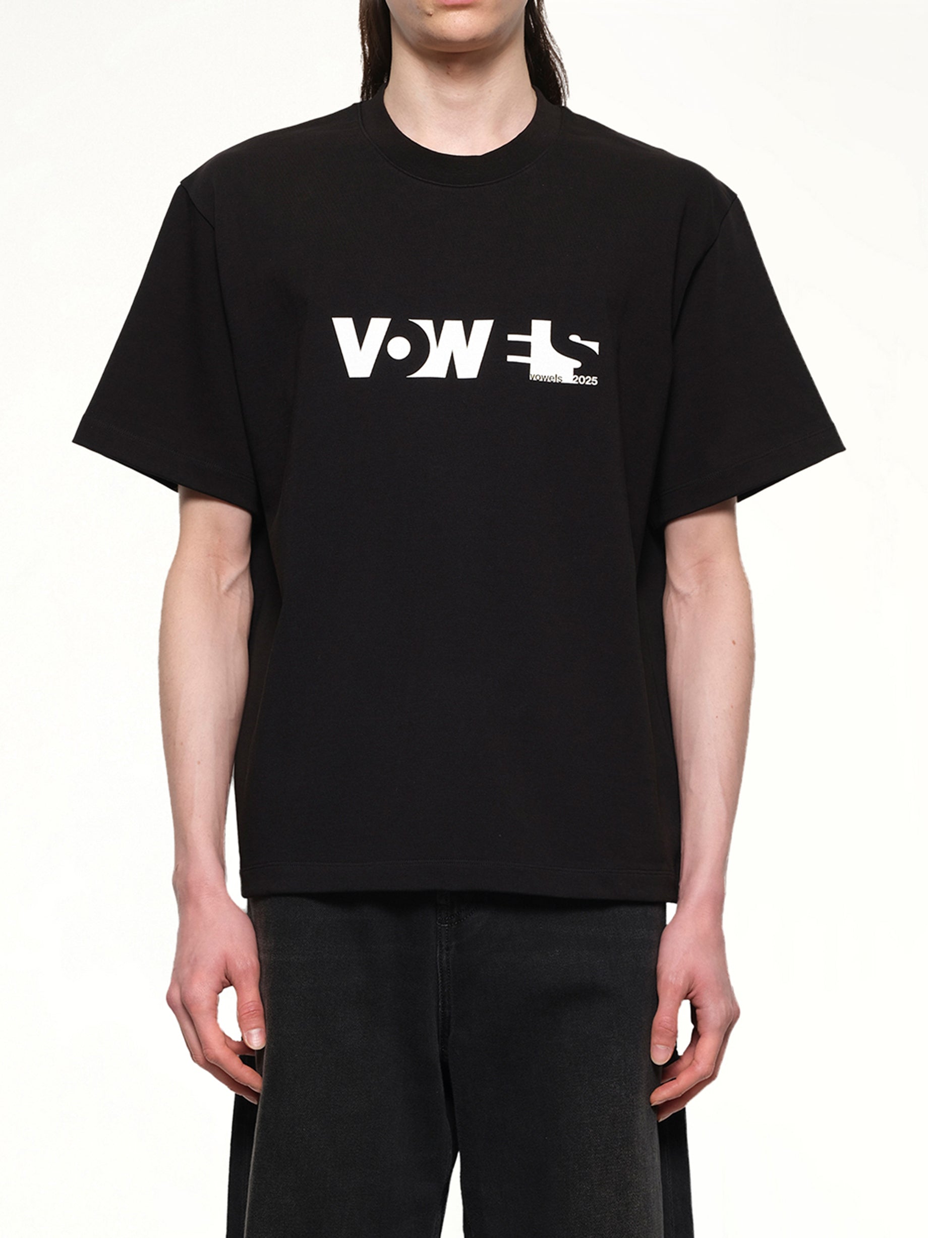 Image of a model wearing Pants. Productname: VOWELS Overall T-Shirt in Black colour by brand - VOWELS