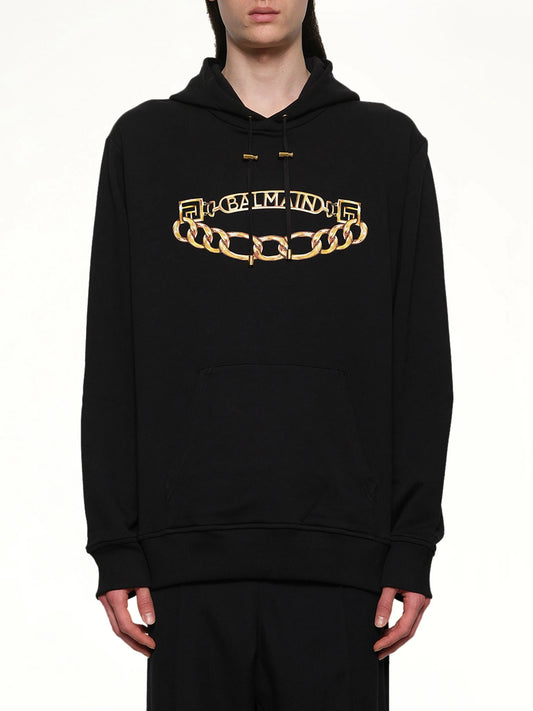 Image of a model wearing Outerwear. Product name - Balmain Chian Logo Hoodie in Black colour by brand - BALMAIN
