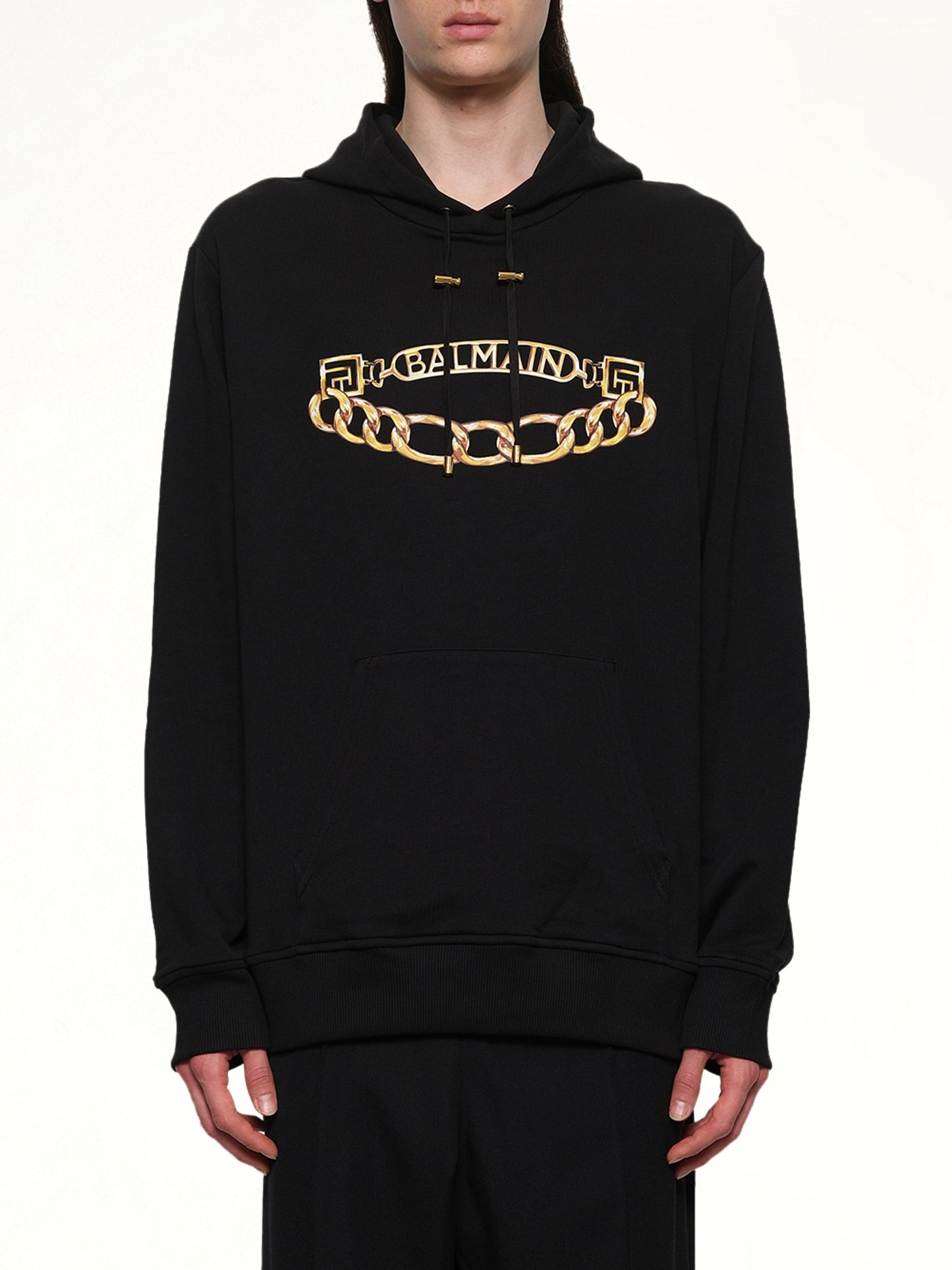 Image of a model wearing Outerwear. Product name - Balmain Chian Logo Hoodie in Black colour by brand - BALMAIN
