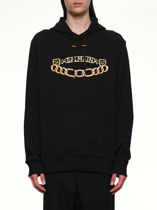 Image of a model wearing Outerwear. Product name - Balmain Chian Logo Hoodie in Black colour by brand - BALMAIN