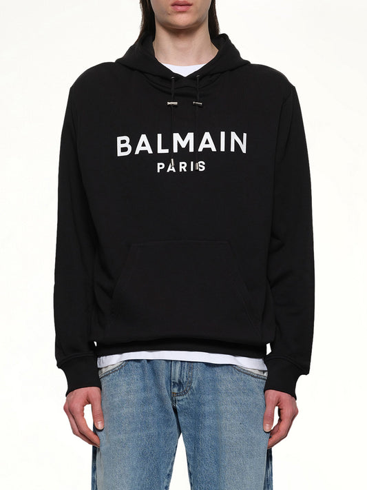 Image of a model wearing Outerwear. Productname: BALMAIN Logo Printed Hoodie in Black/White colour by brand - BALMAIN