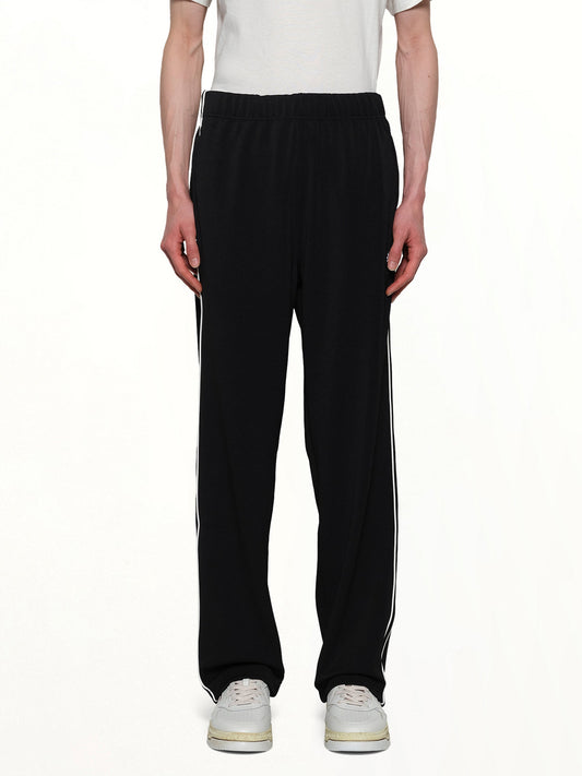 Image of a model wearing Pants. Productname: KENZO Boke Flower 2.0 Trackpants in BLACK colour by brand - KENZO