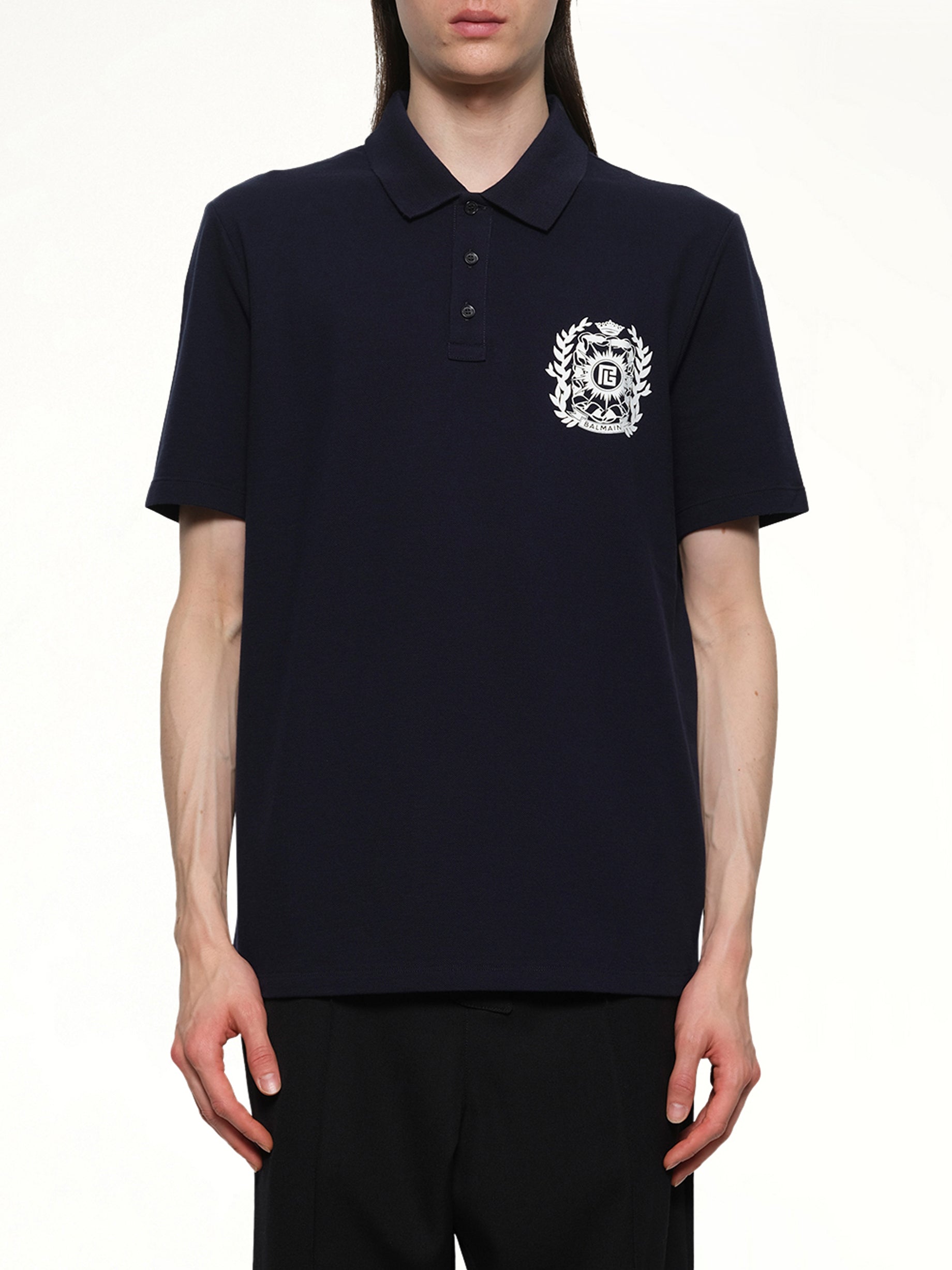 Image of a model wearing Tops. Product name - Balmain Emblem Polo in Navy colour by brand - BALMAIN