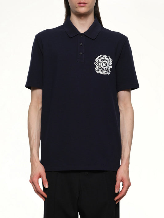 Image of a model wearing Tops. Product name - Balmain Emblem Polo in Navy colour by brand - BALMAIN