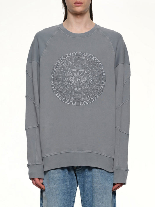 Image of a model wearing Outerwear. Product name - Balmain Medal Sweatshirt in Grey colour by brand - BALMAIN