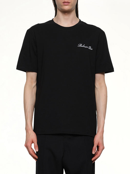 Image of a model wearing Tops. Productname: BALMAIN Balmain Signature Embroidered T-Shirt in BLACK/WHITE colour by brand - BALMAIN