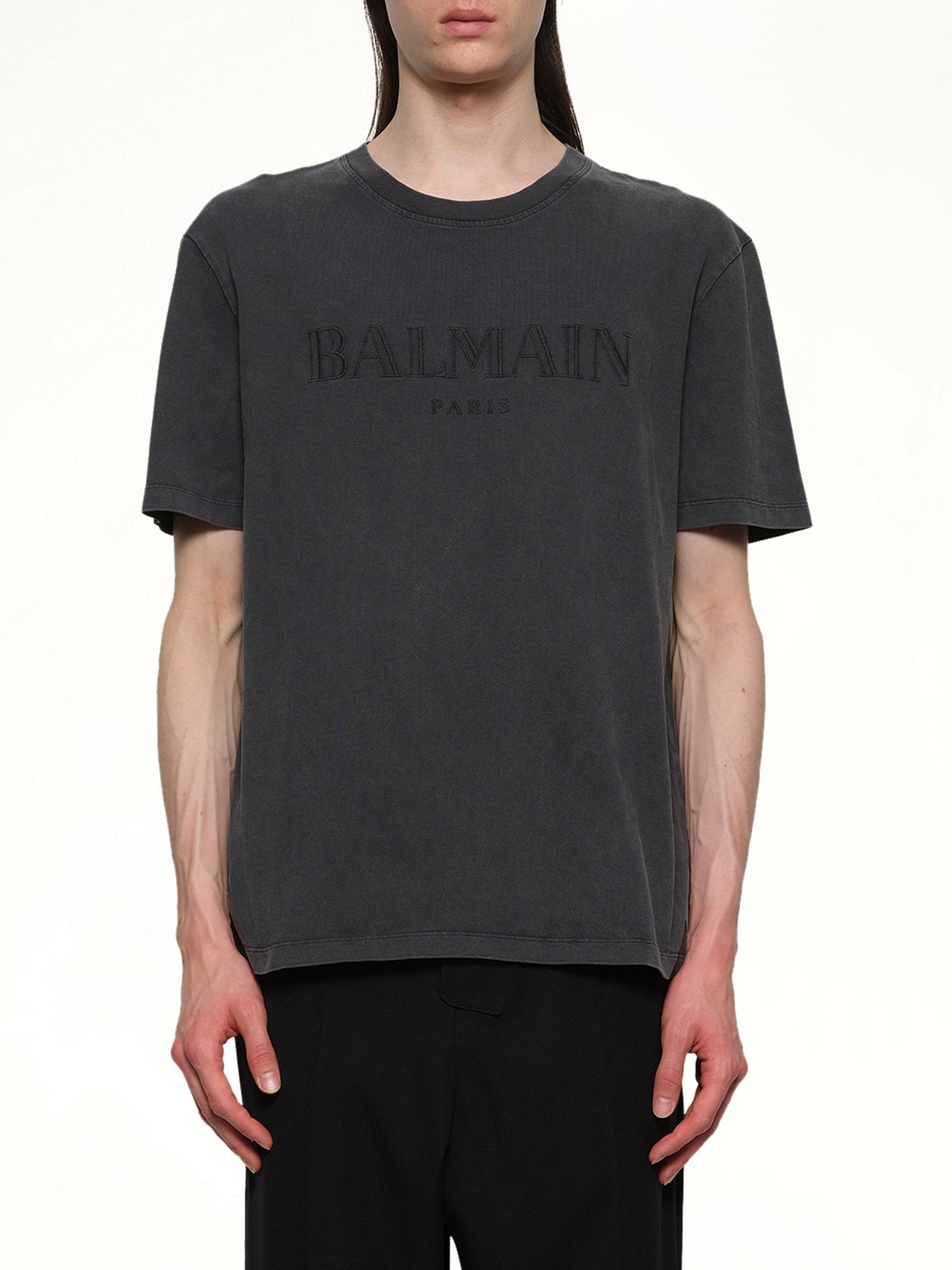 Image of a model wearing Tops. Productname: BALMAIN Balmain Vintage Emblem T-Shirt in Vintage Black colour by brand - BALMAIN