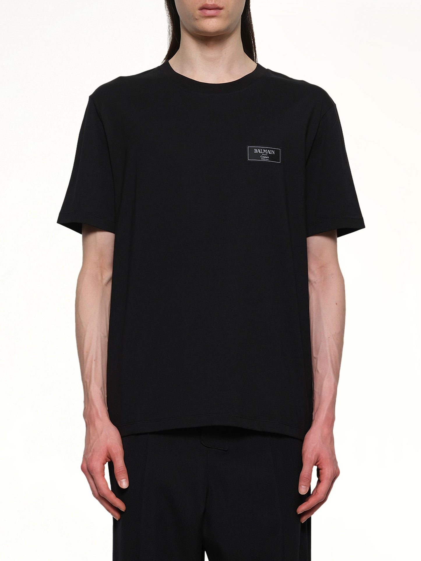 Image of a model wearing Tops. Productname: BALMAIN Couture Label Regular T-Shirt in Black colour by brand - BALMAIN