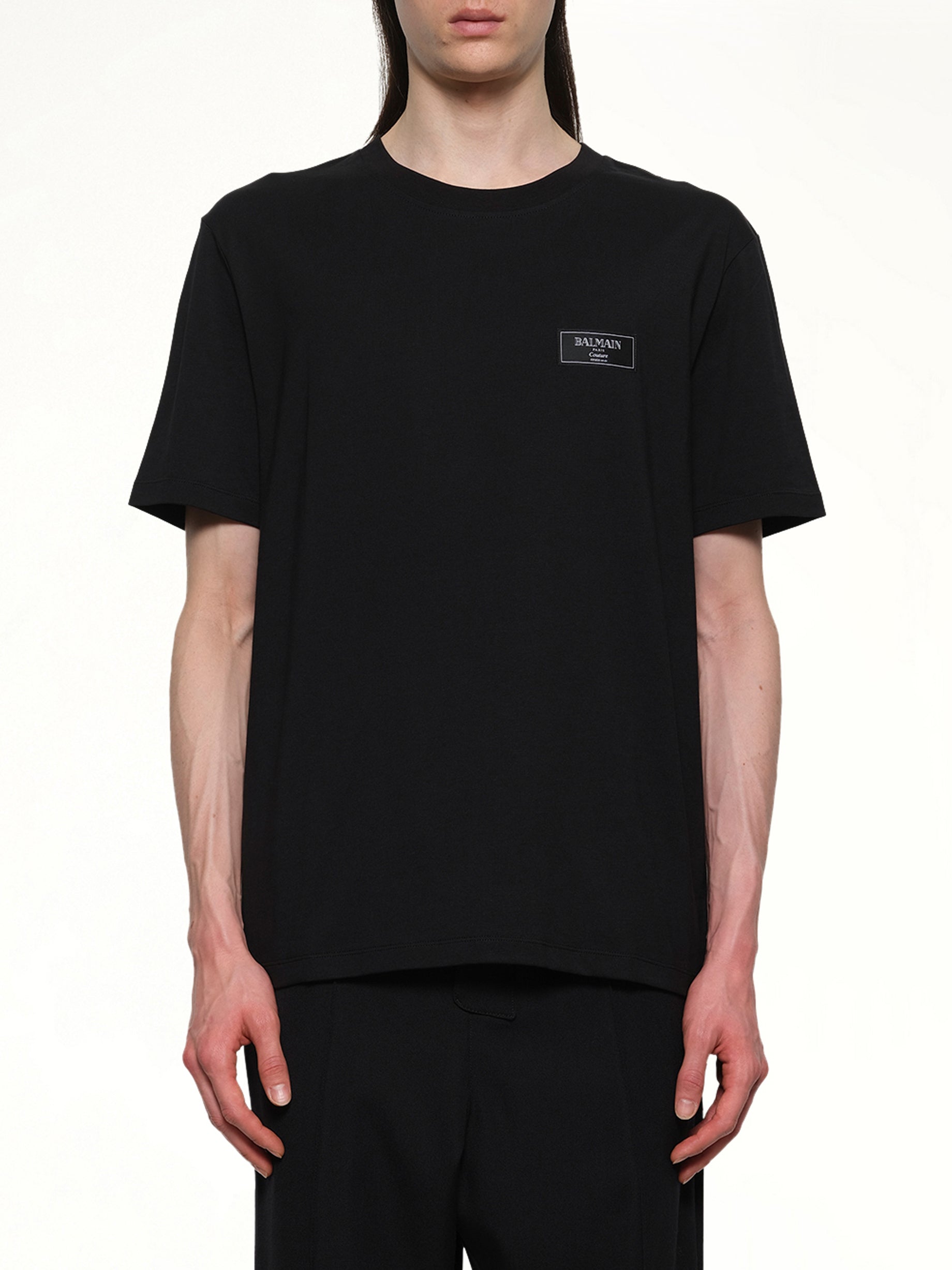 Image of a model wearing Tops. Productname: BALMAIN Couture Label Regular T-Shirt in Black colour by brand - BALMAIN