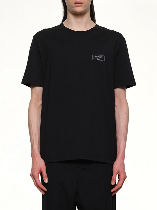 Image of a model wearing Tops. Productname: BALMAIN Couture Label Regular T-Shirt in Black colour by brand - BALMAIN