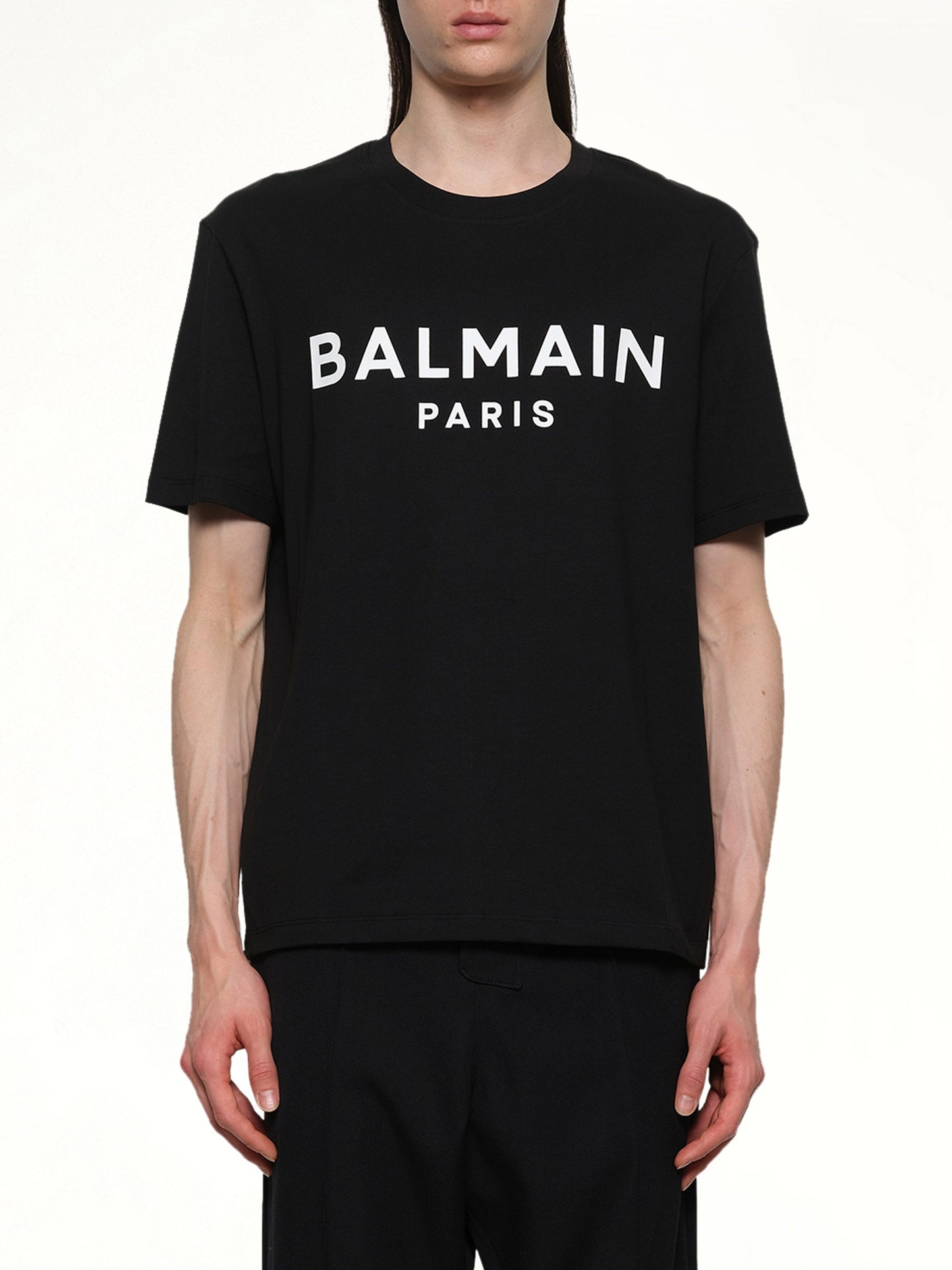 Image of a model wearing Tops. Productname: BALMAIN Logo Printed Straight Fit T-shirt in Black/White colour by brand - BALMAIN