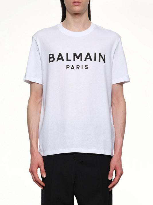 Image of a model wearing Tops. Productname: BALMAIN Logo Printed Straight Fit T-shirt in White/Black colour by brand - BALMAIN