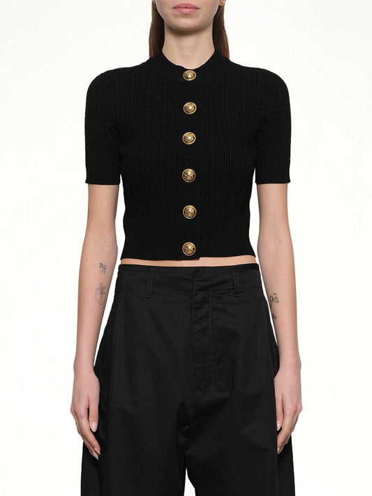Image of a model wearing Outerwear. Productname: BALMAIN SS Buttoned Torsade Knit Cardigan in BLACK colour by brand - BALMAIN