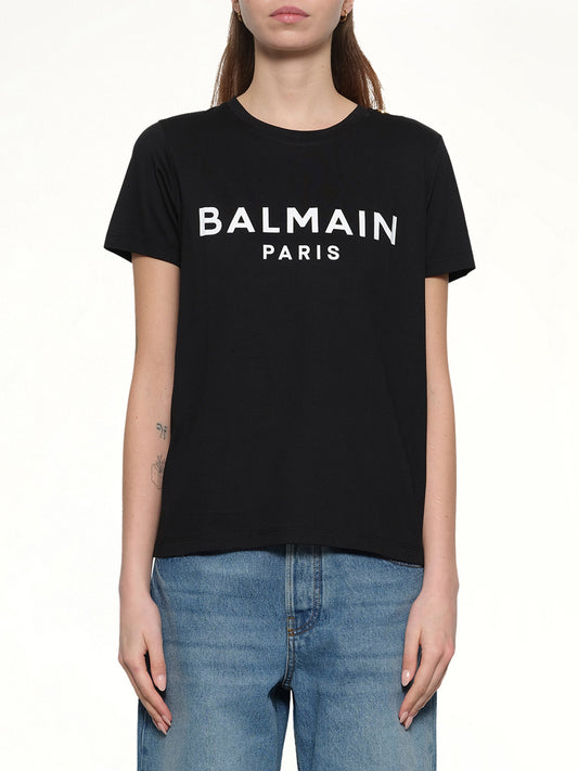 Image of a model wearing Tops. Productname: BALMAIN 3 Button Logo Print T-Shirt in BLACK/WHITE colour by brand - BALMAIN