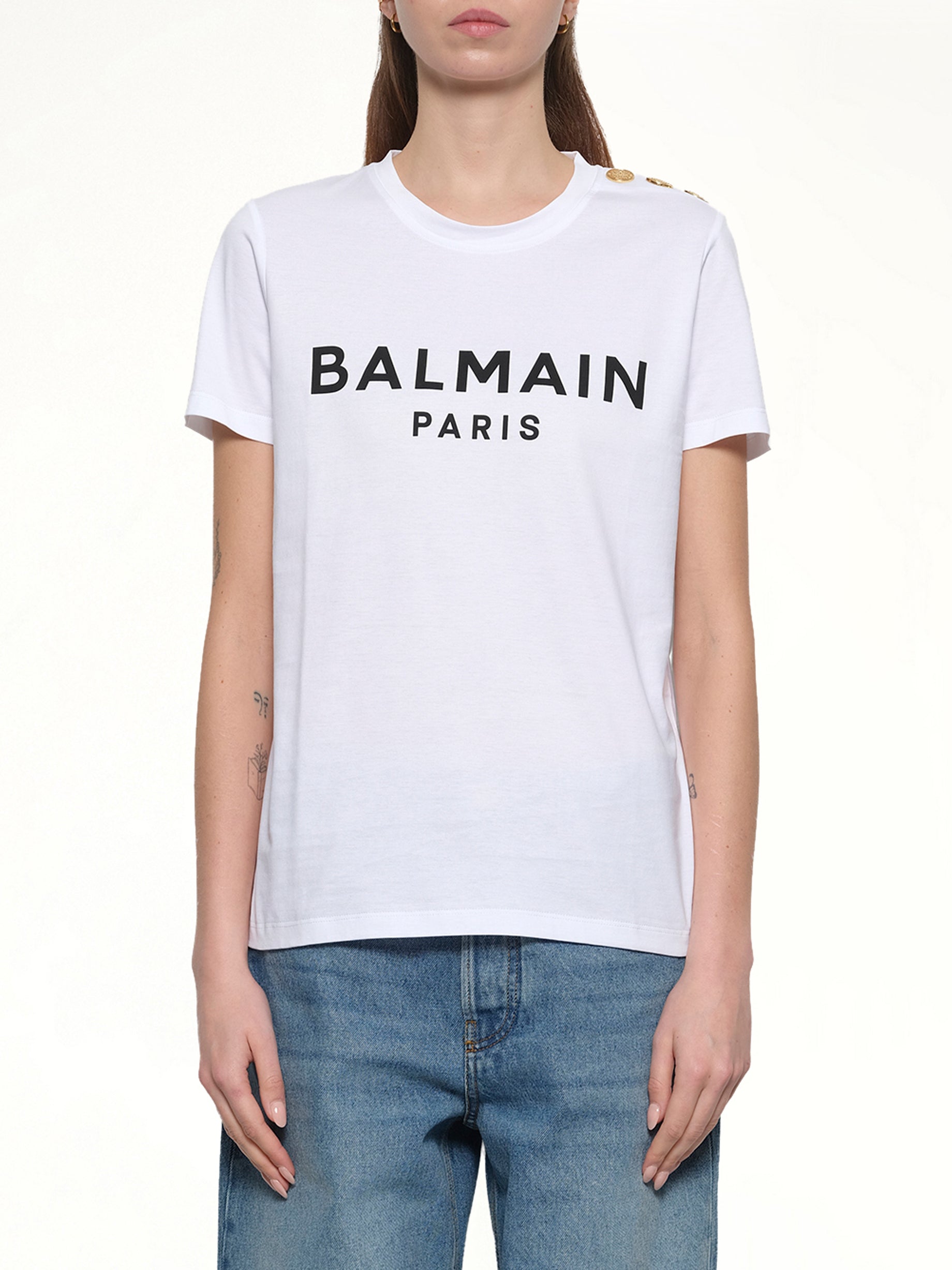 Image of a model wearing Tops. Productname: BALMAIN 3 Button Printed Logo Classic Fit T-Shirt in WHITE/BLACK colour by brand - BALMAIN