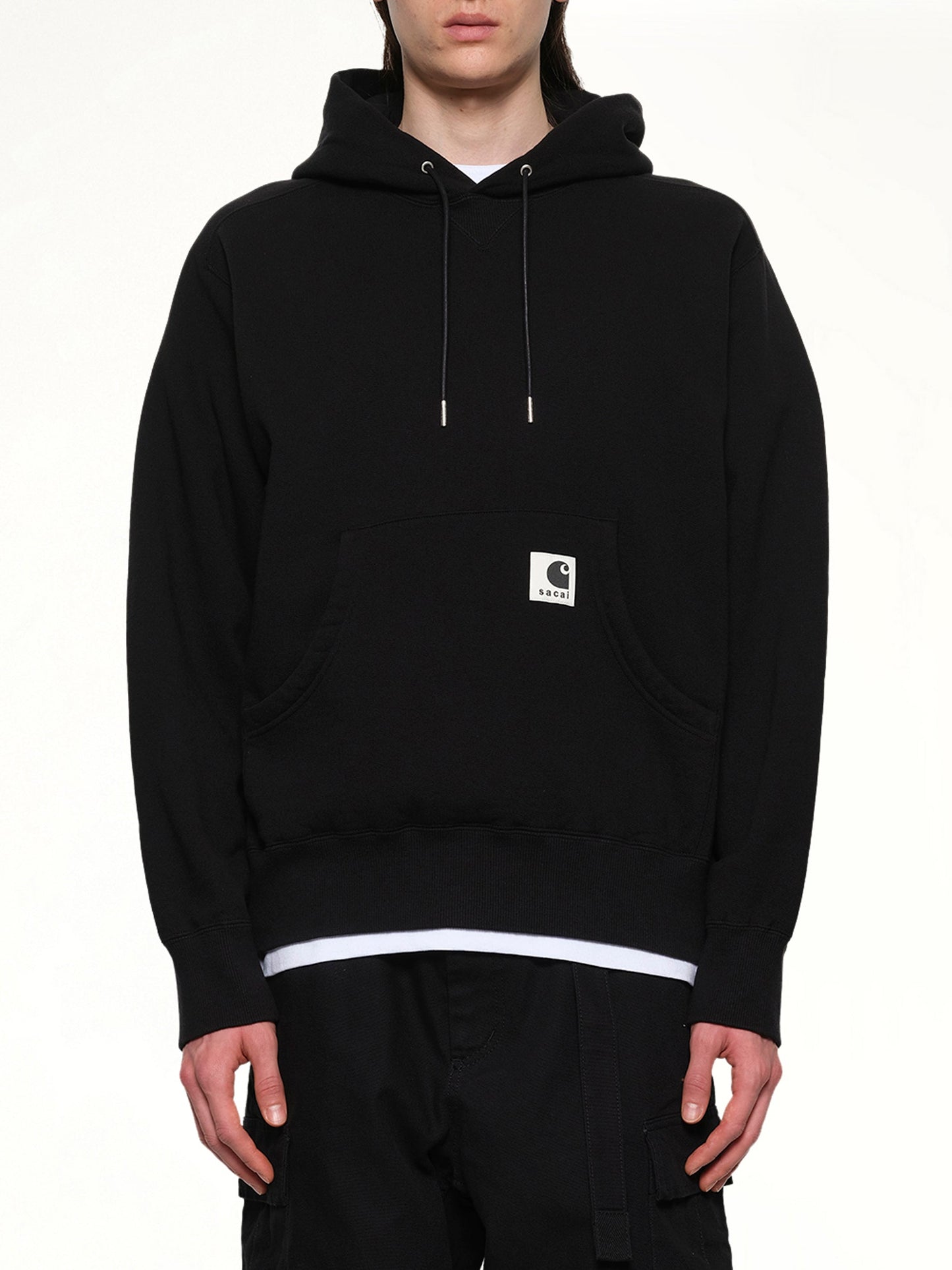 Image of a model wearing Outerwear. Product name - Carhartt WIP Cotton Jersey Hoodie in Black colour by brand - SACAI