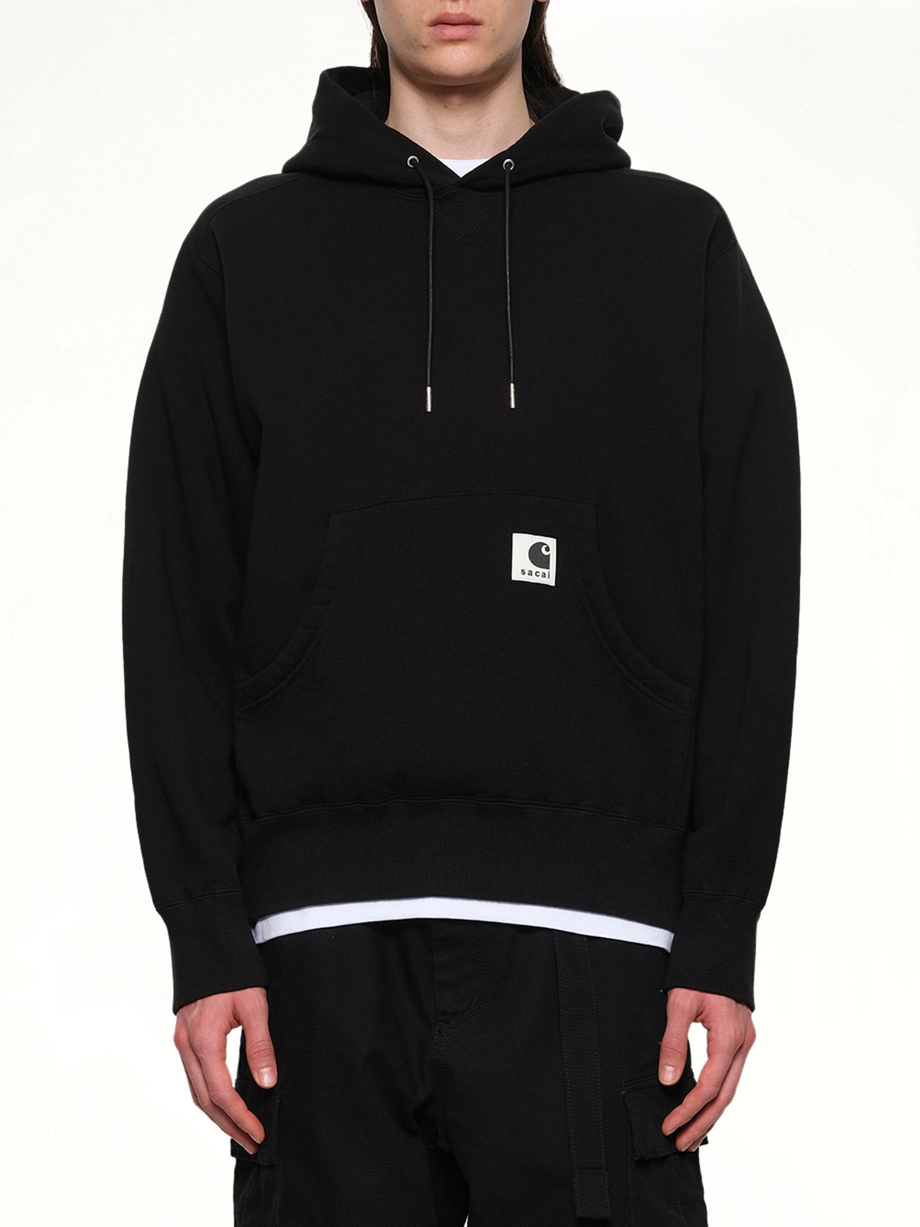 Image of a model wearing Outerwear. Product name - Carhartt WIP Cotton Jersey Hoodie in Black colour by brand - SACAI